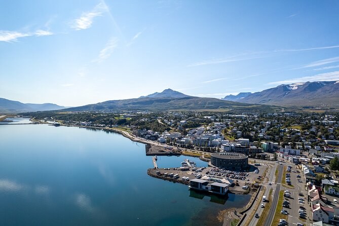 Akureyri from the air, spread along the shore of a long, still fjord